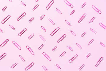 Paper clips on pastel pink background. Top view, flat lay. Back to school concept. College, institute education, office work