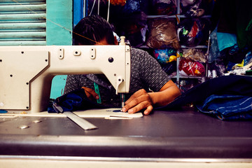 Man arranging thread in sewing machine