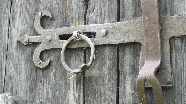 Close-up of an iron hasp lock on old wood