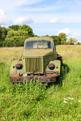 abandoned rusty old truck car in the field