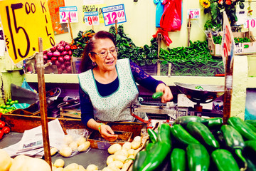 Candid portrait of woman selling vegetables in stall