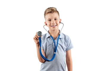 Smiling boy holding a stethoscope in his hands on an isolated light background. Medical education, choice of profession, future doctor.