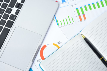 Business and Finances Concepts. Laptop, Notebook with graph and pen