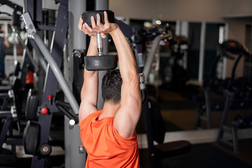 Asian man is working out  in fitness gym