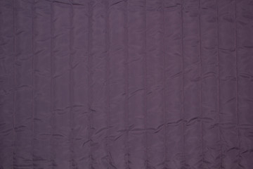 Fabric quilted lilac. The texture of the quilted jackets. 
