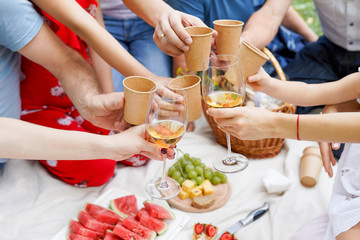 Obraz na płótnie Canvas Hands with white wine toasting over served table with food. Family Happiness Enjoying Dinning Eating Concept.