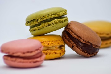 Multi color macaroon stacked together with depth of field on a white background