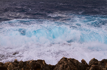 Huge waves crash on cloudy day. Kemmuna island