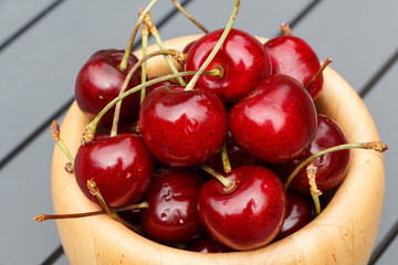 Cherries in a bowl made in wood