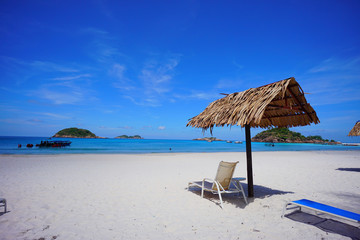 Beach chair with umbrella with blue sky on tropical beach