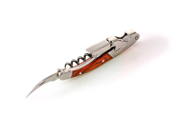 Sommelier knife with corkscrew and bottle opener with open bottle foil pruning blade, professionsl waiter knife, close up.