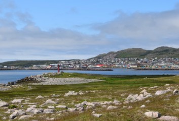 view across the meadow on the southern tip of Ile aux towards the lighthouse, city of Saint Pierre...