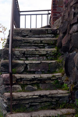 Korela citadel; old stone staircase covered with moss and part of the masonry of the fortress wall