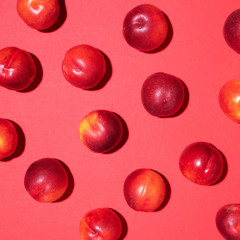 Nectarines pattern on red background. Frame made of fresh fruits. Flat lay, top view, copy space. Vegan and vegetarian diet