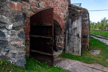 Fototapeta na wymiar old wooden gate to the stone watchtower of Korela fortress