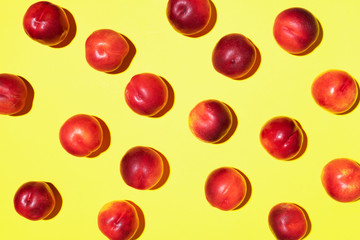 Nectarines pattern on yellow background. Frame made of fresh fruits. Flat lay, top view, copy space. Vegan and vegetarian diet