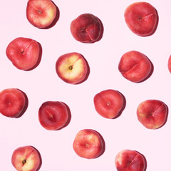 Peaches pattern on pastel pink background. Frame made of fresh fruits. Flat lay, top view, copy space. Vegan and vegetarian diet