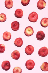 Peaches pattern on pastel pink background. Frame made of fresh fruits. Flat lay, top view, copy space. Vegan and vegetarian diet