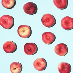 Peaches pattern on pastel blue background. Frame made of fresh fruits. Flat lay, top view, copy space. Vegan and vegetarian diet