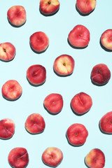 Peaches pattern on pastel blue background. Frame made of fresh fruits. Flat lay, top view, copy space. Vegan and vegetarian diet