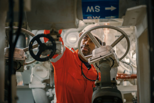 Employee inspect machinery on offshore vessel