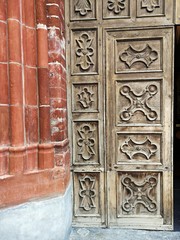 Old wooden church door - retro style wooden door with artistic details