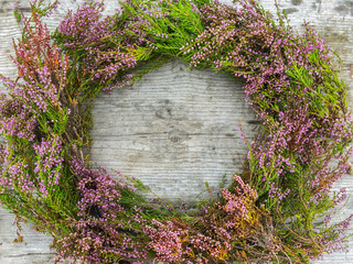 Heather wreath Calluna vulgaris. Beautiful wreath on a wooden background. Christmas and New Year greeting card layout