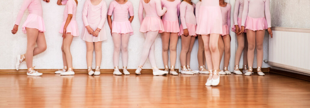 Little girls learn to dance ballet at dance school
