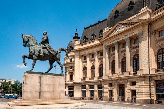 The bronze equestrian statue of king Carol the first and university in romanian capital's revolution square