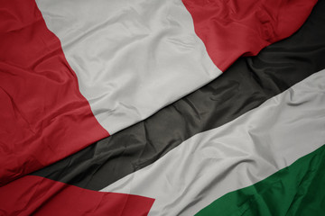 waving colorful flag of palestine and national flag of peru.