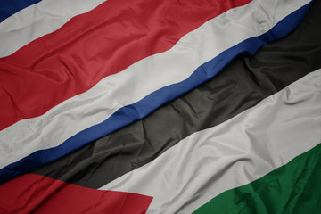 waving colorful flag of palestine and national flag of costa rica.