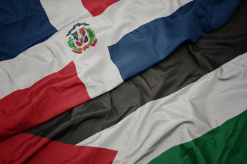waving colorful flag of palestine and national flag of dominican republic.