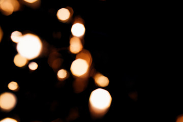 Golden abstract bokeh sparkle on black isolated background. Holiday concept. Place for design. Festive concept.