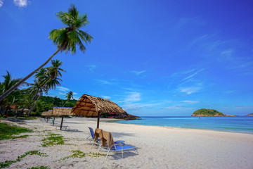 Beach chair with umbrella with blue sky on tropical beach