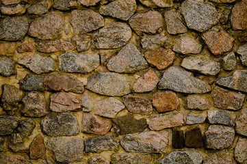 Masonry. Old masonry. The wall is built of stone. Architectural texture. Building stone.