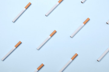 A lot of cigarettes on blue background. Cigarettes pattern.