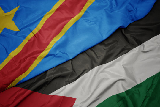 waving colorful flag of palestine and national flag of democratic republic of the congo.
