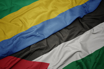 waving colorful flag of palestine and national flag of gabon.