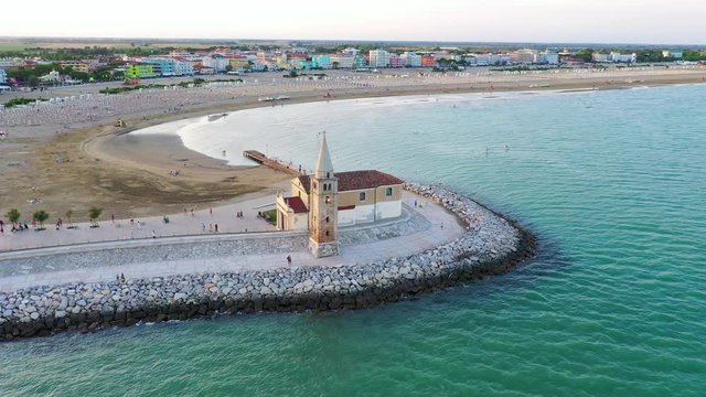 Caorle Madonna dell´Angelo cathedral church. Aerial view to town and beach during a beautiful summer evening.