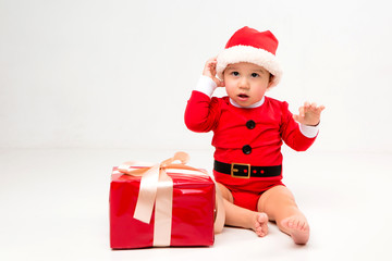  two toddlers in Santa Claus costumes with gift box on white isolate background