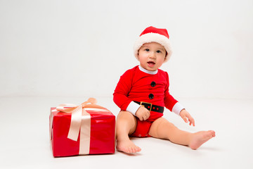  two toddlers in Santa Claus costumes with gift box on white isolate background