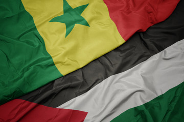 waving colorful flag of palestine and national flag of senegal.