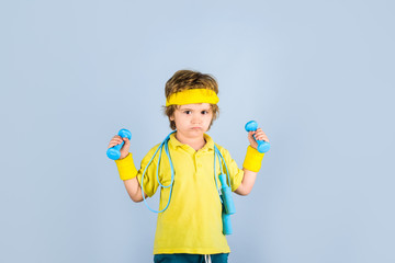 Childhood activity. Fitness, health and energy. Sport. Fitness child. Sporty boy with jump rope and dumbbells. Boy in sportwear with skipping rope and dumbbells. Gym workout. Success. Child sportsman.