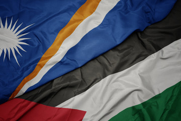 waving colorful flag of palestine and national flag of Marshall Islands .