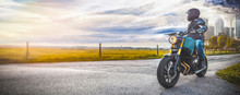 man on motorbike on the road. having fun driving the empty road on a motorcycle tour journey. copyspace for your individual text.