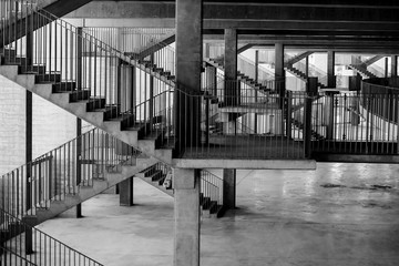 Black and white image with the architecture and various staircases and patterns inside a soccer...