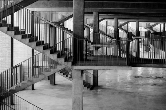 Black and white image with the architecture and various staircases and patterns inside a soccer stadium