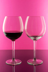 Red wine in Elegant glasses isolated on pink background. Wine concept. 