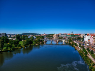 Fototapeta na wymiar aerial flight over vltava river next to bridges sunny day of summer in Prague