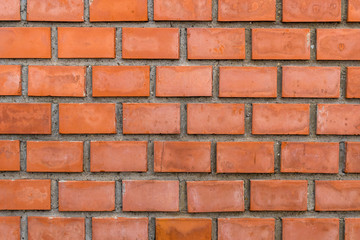 Closeup view of red brick well-built wall background.